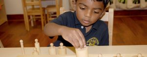 Montessori Cumming boy with blocks