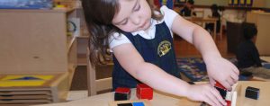Montessori Cumming girl with blocks