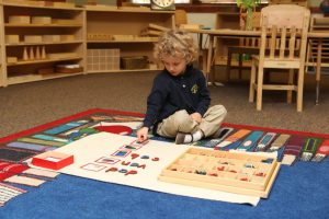 Montessori girl working with letters